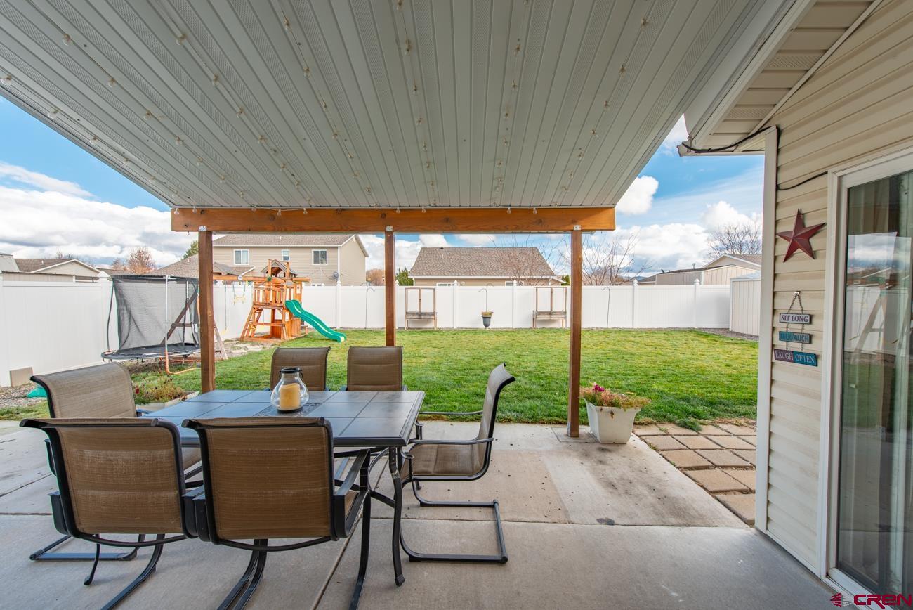 111 6675th Road Montrose, CO 81401 - Photo 33 of 40 a view of an chairs and table in the patio