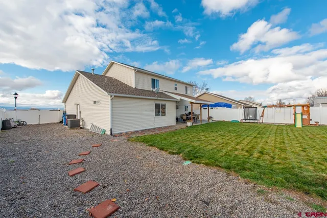 a view of a house with a backyard