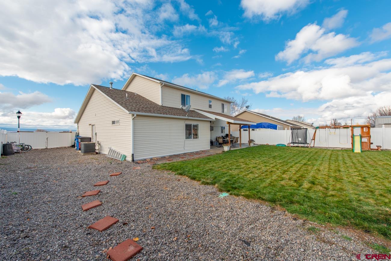 111 6675th Road Montrose, CO 81401 - Photo 35 of 40 a front view of a house with a yard and garage
