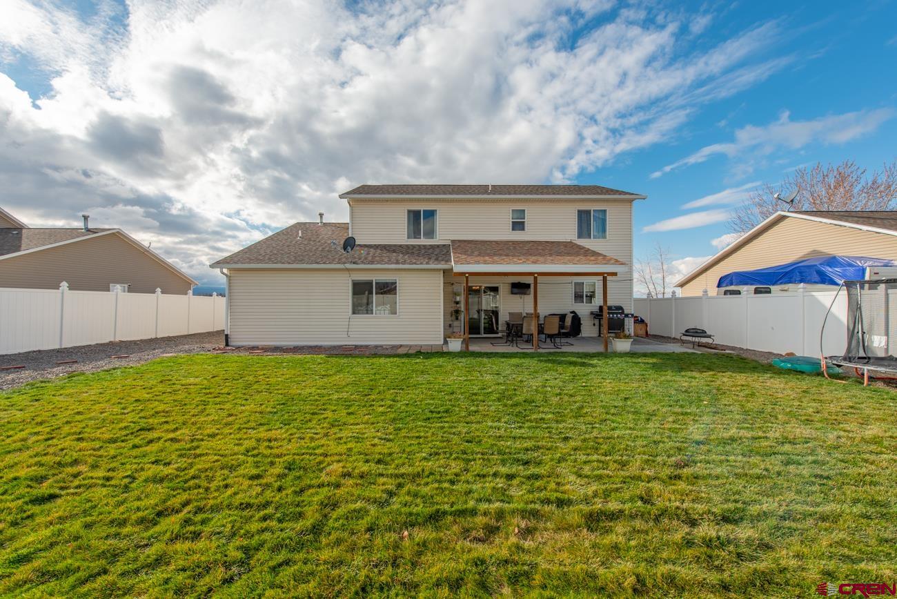 111 6675th Road Montrose, CO 81401 - Photo 36 of 40 a view of a house with a backyard