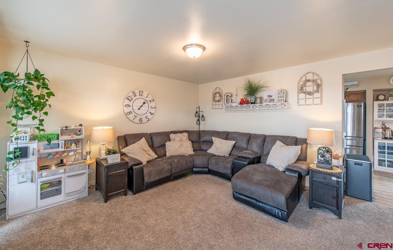 111 6675th Road Montrose, CO 81401 - Photo 5 of 40 a living room with furniture and a potted plant
