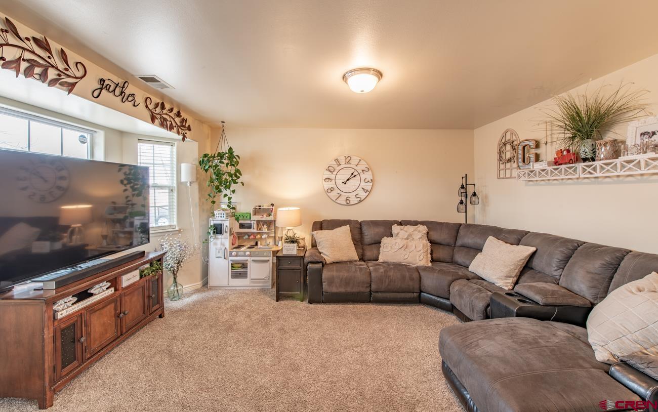 111 6675th Road Montrose, CO 81401 - Photo 6 of 40 a living room with furniture and a flat screen tv