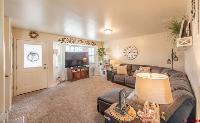 a living room with furniture and a stairs