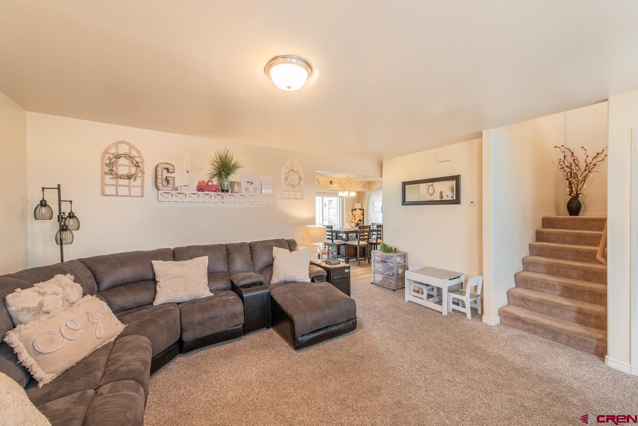 111 6675th Road Montrose, CO 81401 - Photo 8 of 40 a living room with furniture and a stairs