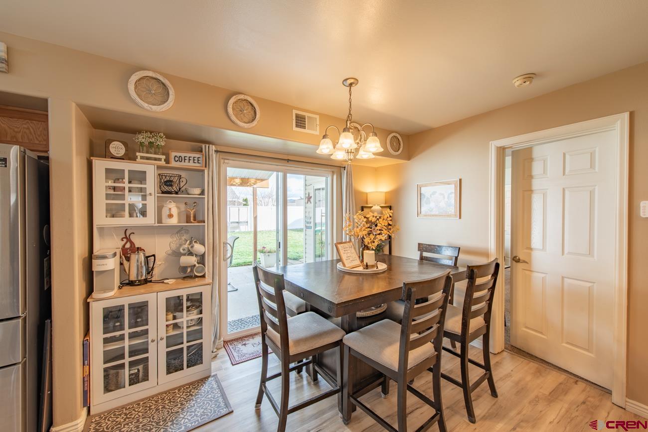 111 6675th Road Montrose, CO 81401 - Photo 9 of 40 a view of a dining room with furniture window and wooden floor