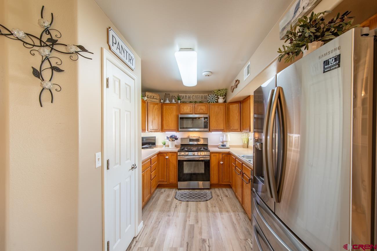 111 6675th Road Montrose, CO 81401 - Photo 10 of 40 a kitchen with stainless steel appliances granite countertop a stove a refrigerator and a refrigerator