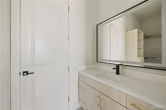 a bathroom with a sink and mirror