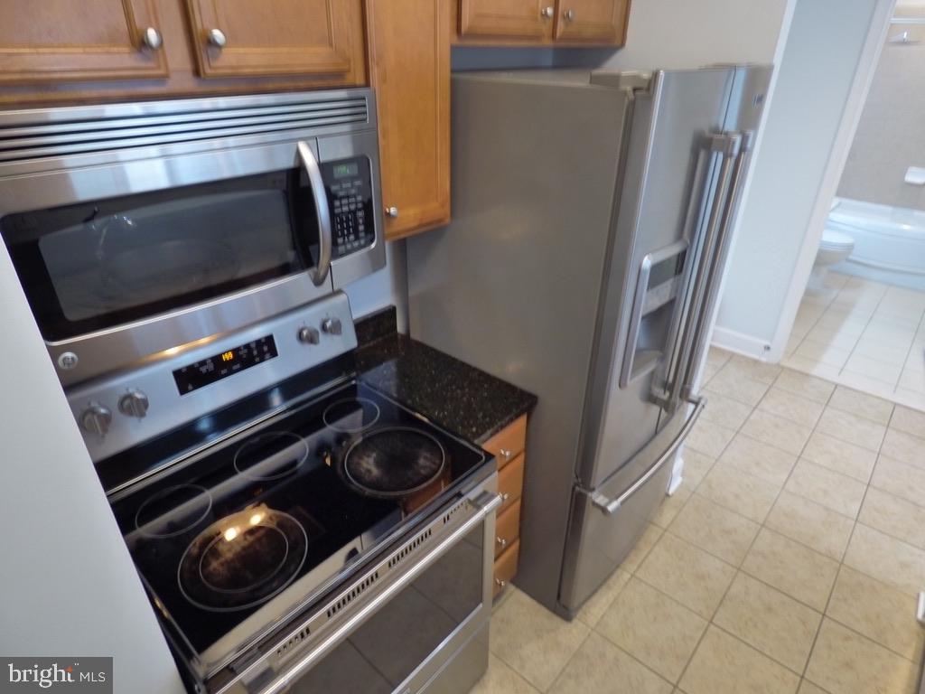 11800 Sunset Hills Road, Unit 118 Reston, VA 20190 - Photo 13 of 52 Modern kitchen with sleek appliances.