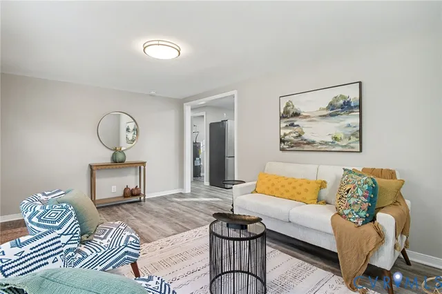 a bedroom with furniture and a wooden floor
