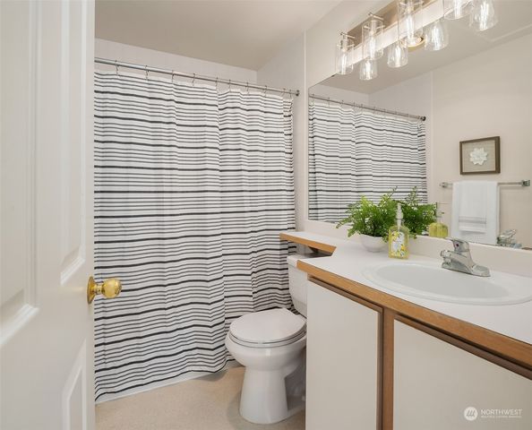 a bathroom with a sink a toilet and mirror