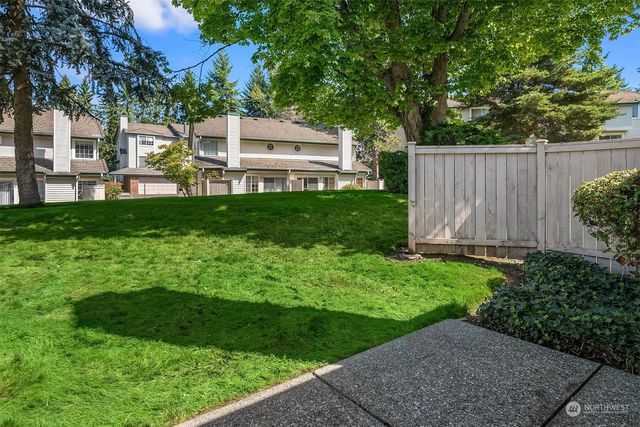 a view of backyard with a garden and trees