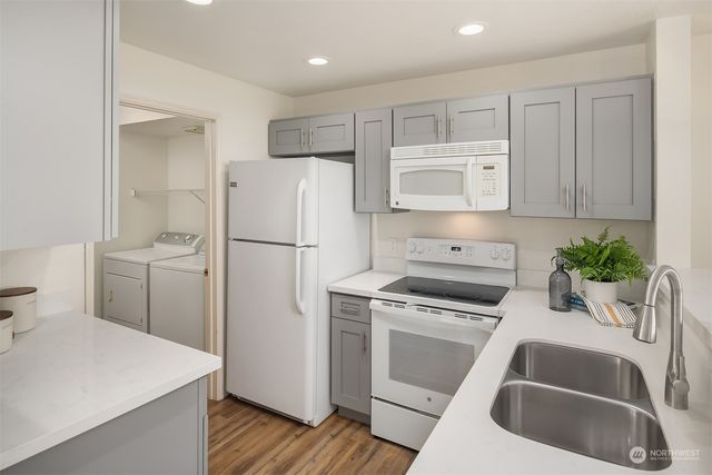 a kitchen with a refrigerator sink and stove