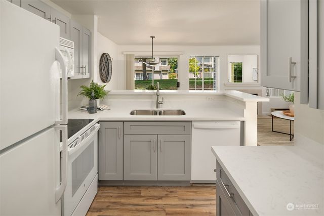 a kitchen with a sink stove and cabinets