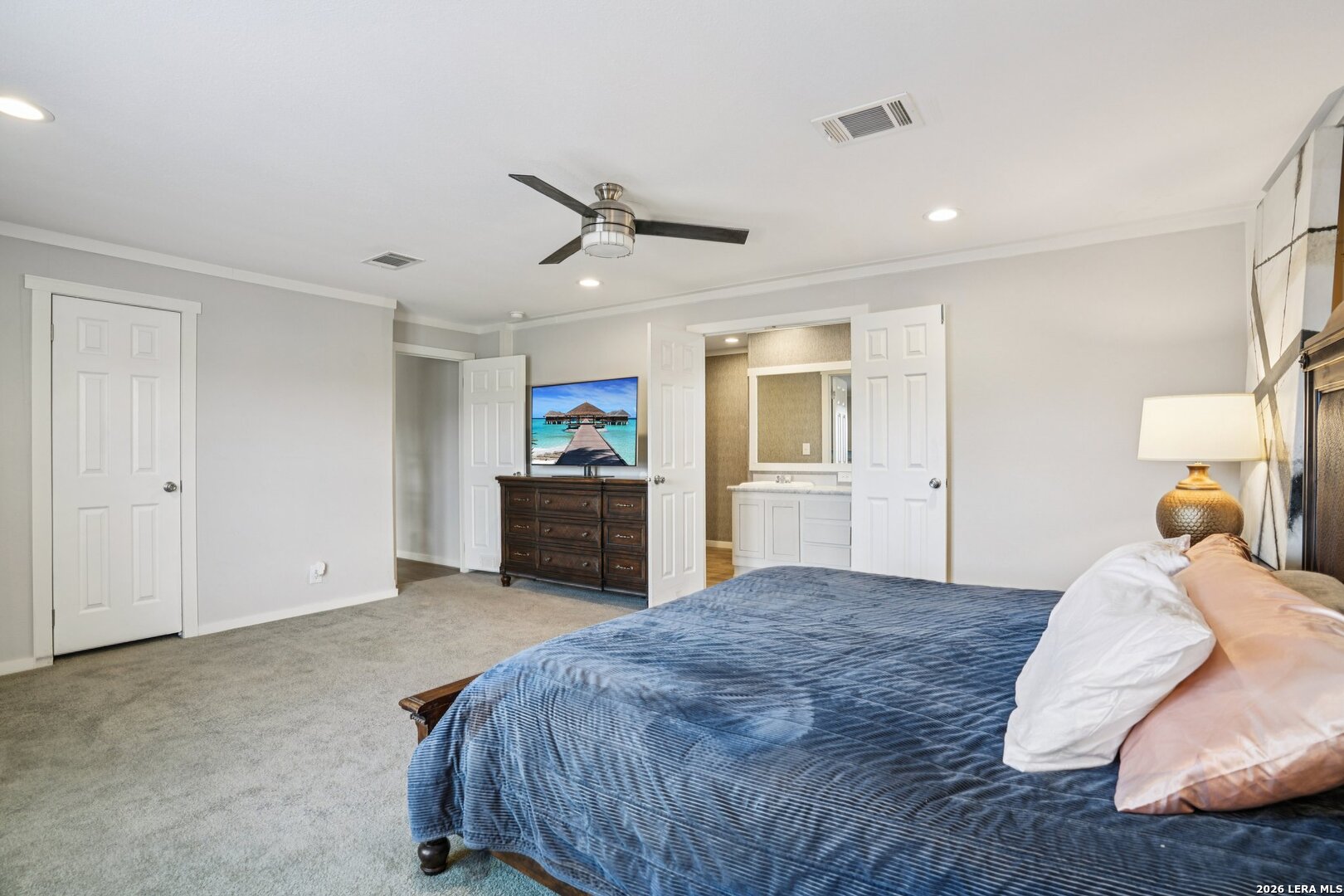 4045 Jakes Colony Road Seguin, TX 78155 - Photo 15 of 36 a spacious bedroom with a large bed and a chandelier