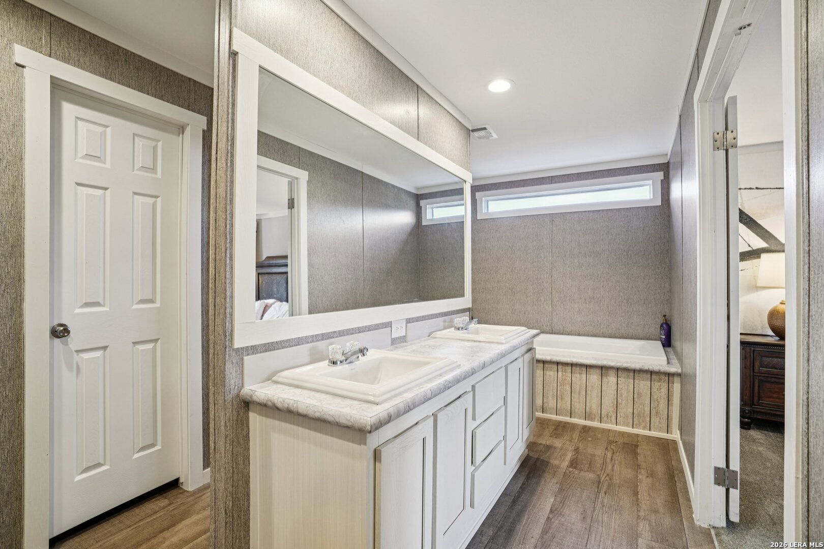 4045 Jakes Colony Road Seguin, TX 78155 - Photo 18 of 36 a bathroom with a sink a mirror and a shower