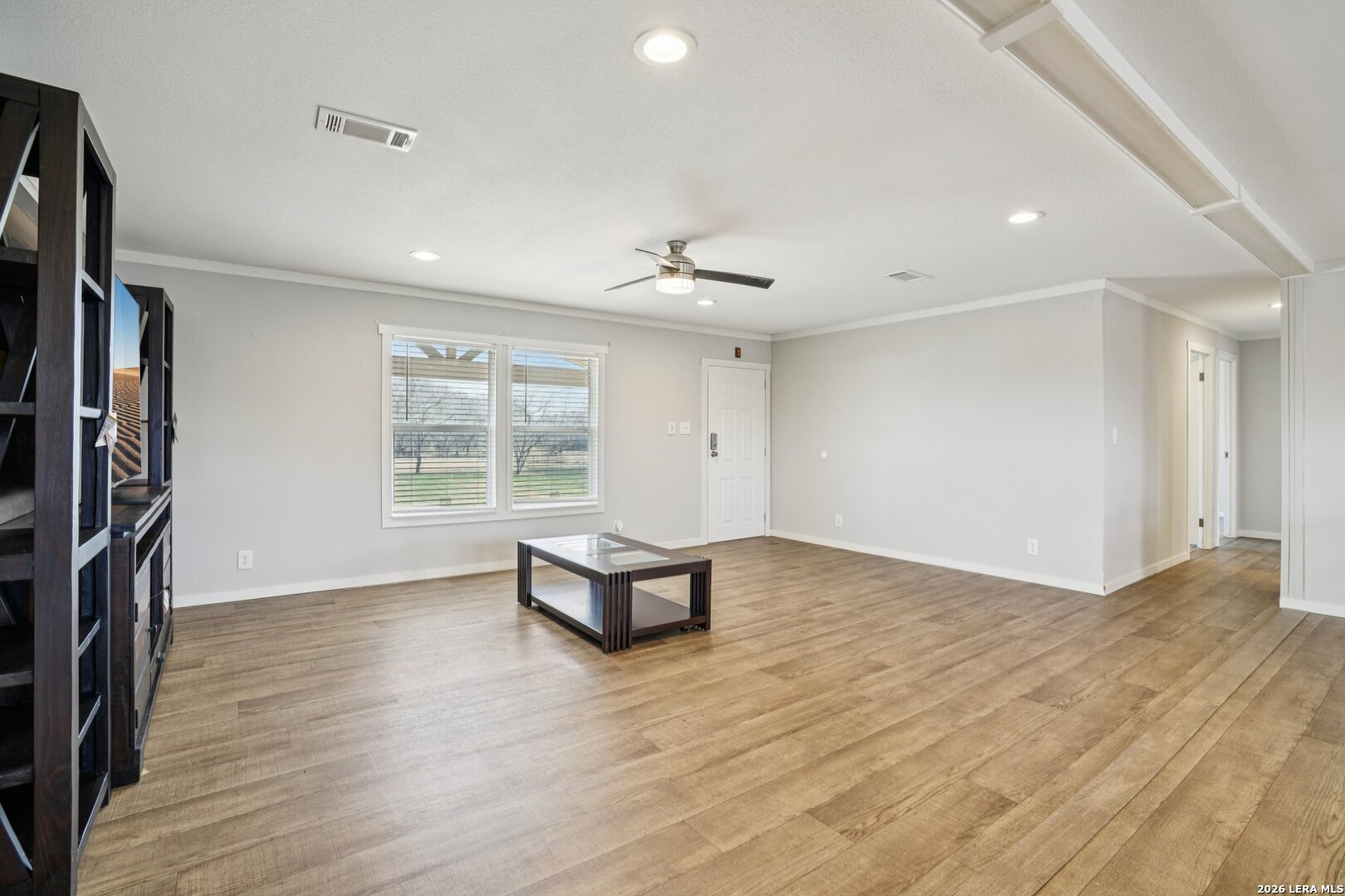 4045 Jakes Colony Road Seguin, TX 78155 - Photo 5 of 36 an empty room with wooden floor and a window