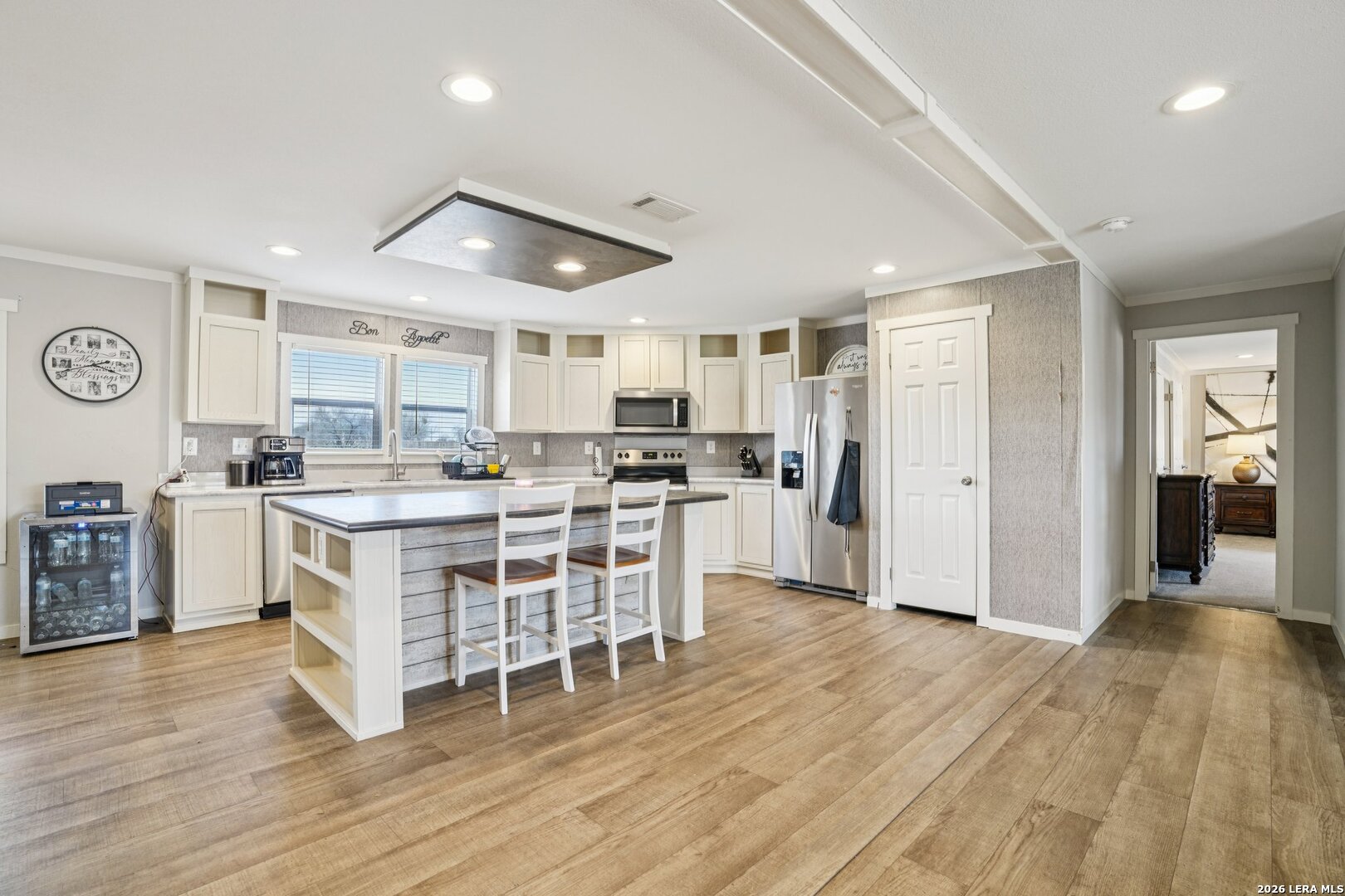 4045 Jakes Colony Road Seguin, TX 78155 - Photo 10 of 36 a kitchen with a center island wooden floor stainless steel appliances and cabinets