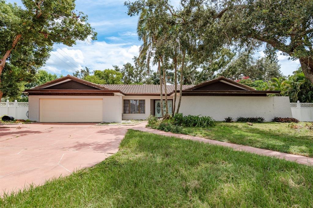 a front view of a house with a garden and yard