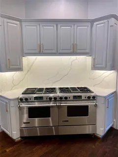 a stove top oven sitting inside of a kitchen