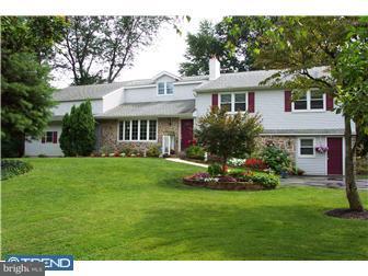a front view of a house with a garden and porch