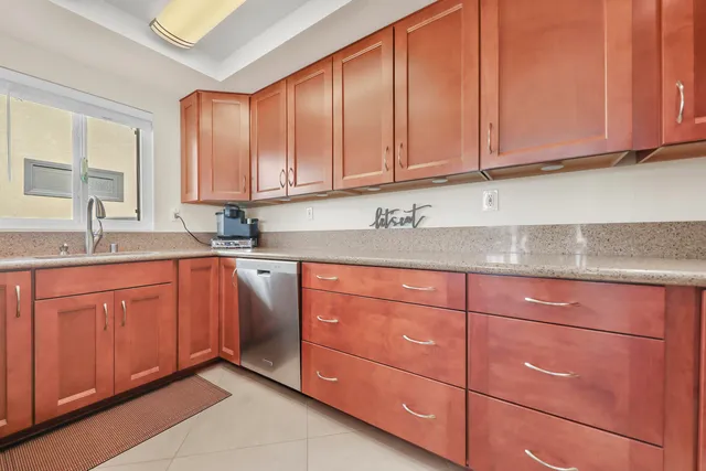 a kitchen with stainless steel appliances granite countertop cabinets and window