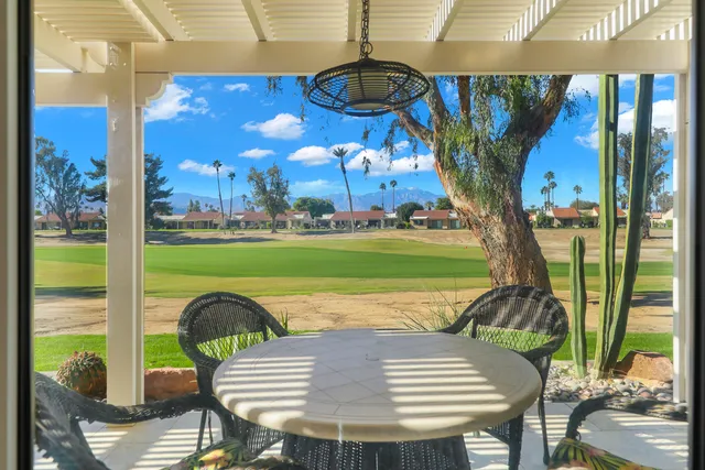 a view of a swimming pool with a patio and a yard