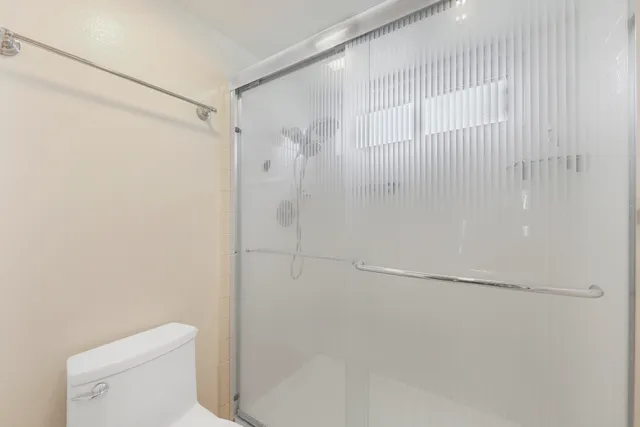 a bathroom with a shower and a toilet