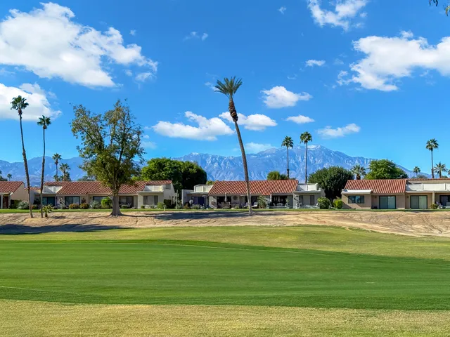 a swimming pool with outdoor seating and yard