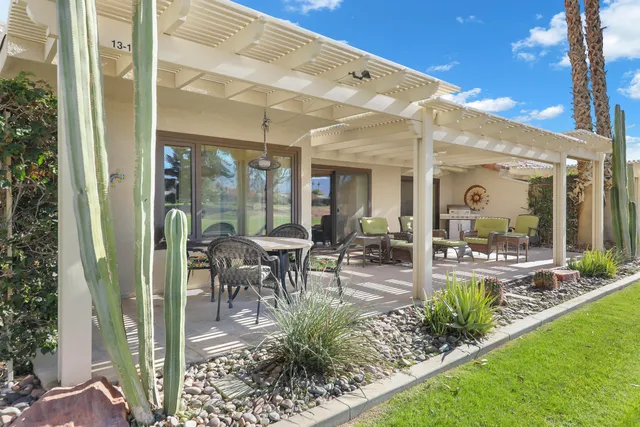 a view of a patio with table and chairs potted plants