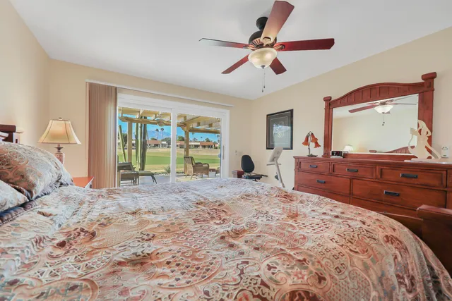 a bedroom with a large bed and a dresser