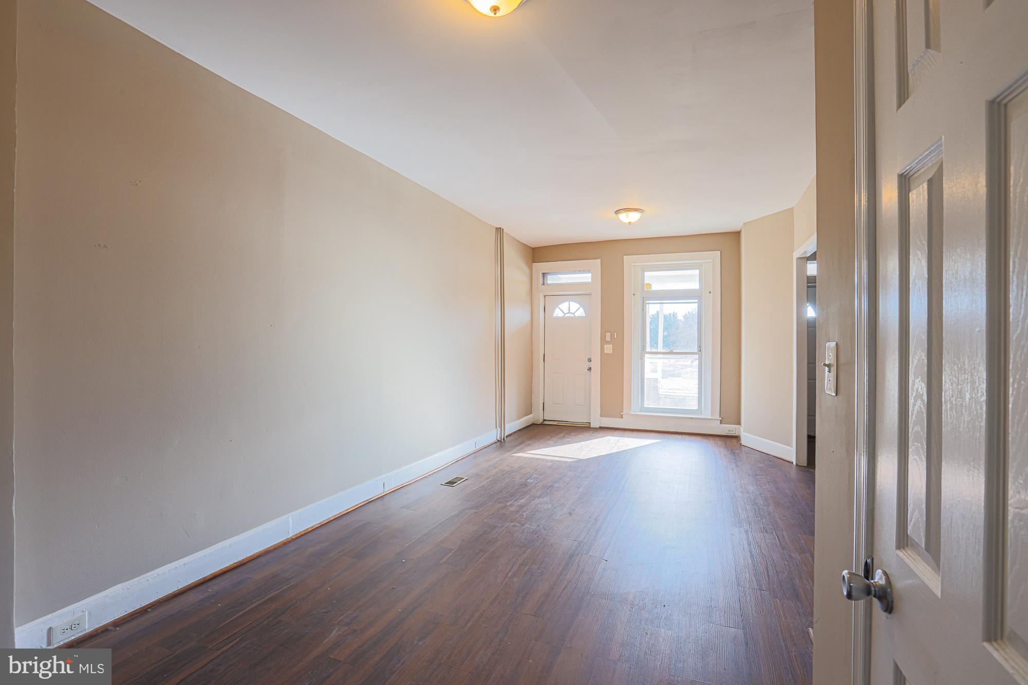 3012 Harford Road Baltimore, MD 21218 - Photo 11 of 42 a view of an empty room with wooden floor and a window