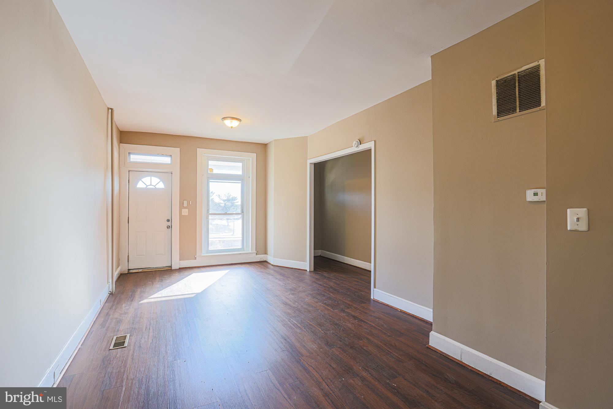 3012 Harford Road Baltimore, MD 21218 - Photo 13 of 42 a view of an empty room with wooden floor and windows