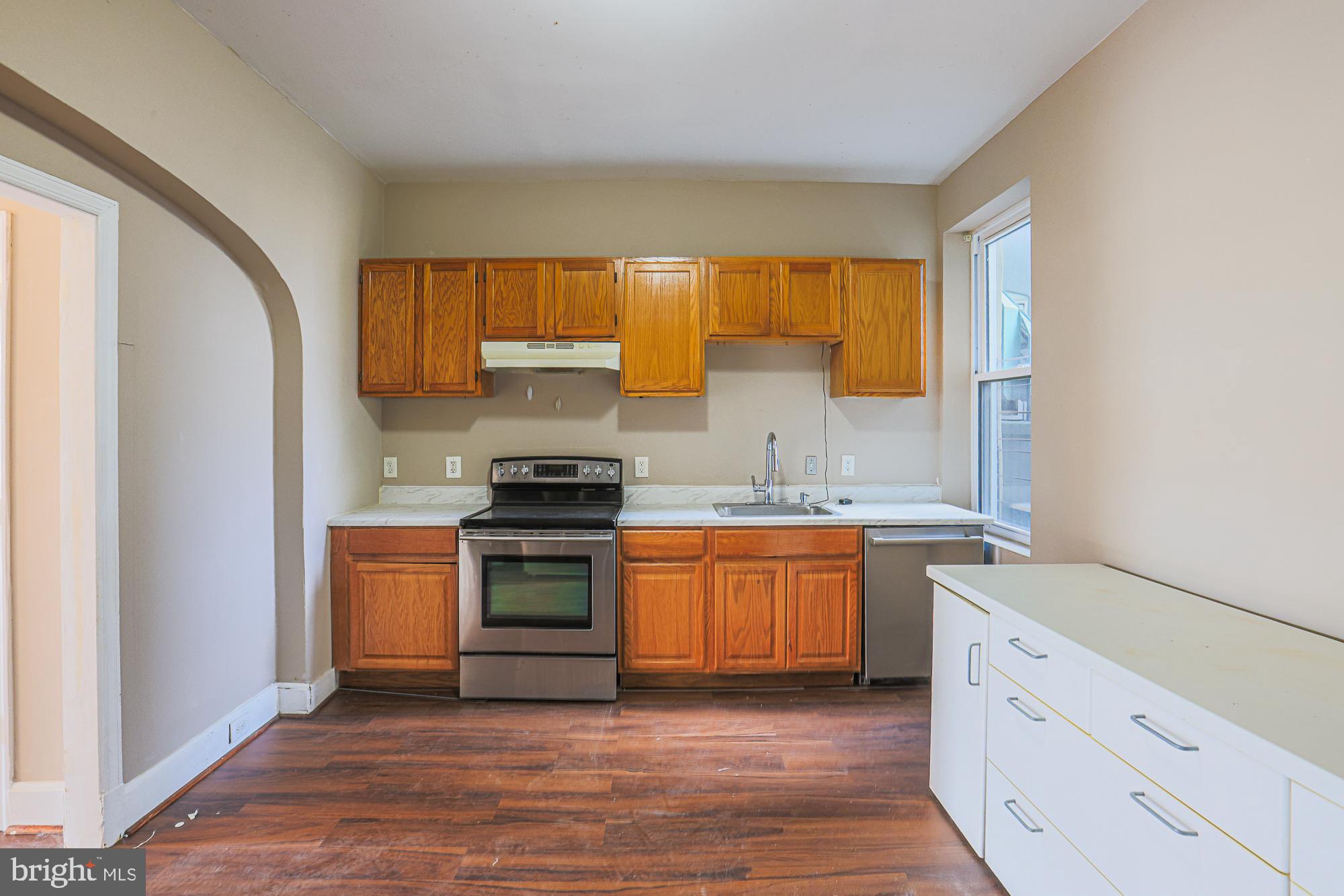 3012 Harford Road Baltimore, MD 21218 - Photo 15 of 42 a kitchen with stainless steel appliances granite countertop a stove a sink and a refrigerator