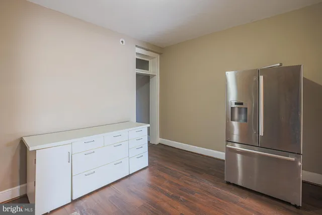 a view of a kitchen with wooden floor and electronic appliances