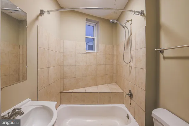 a bathroom with a sink a toilet and a bathtub