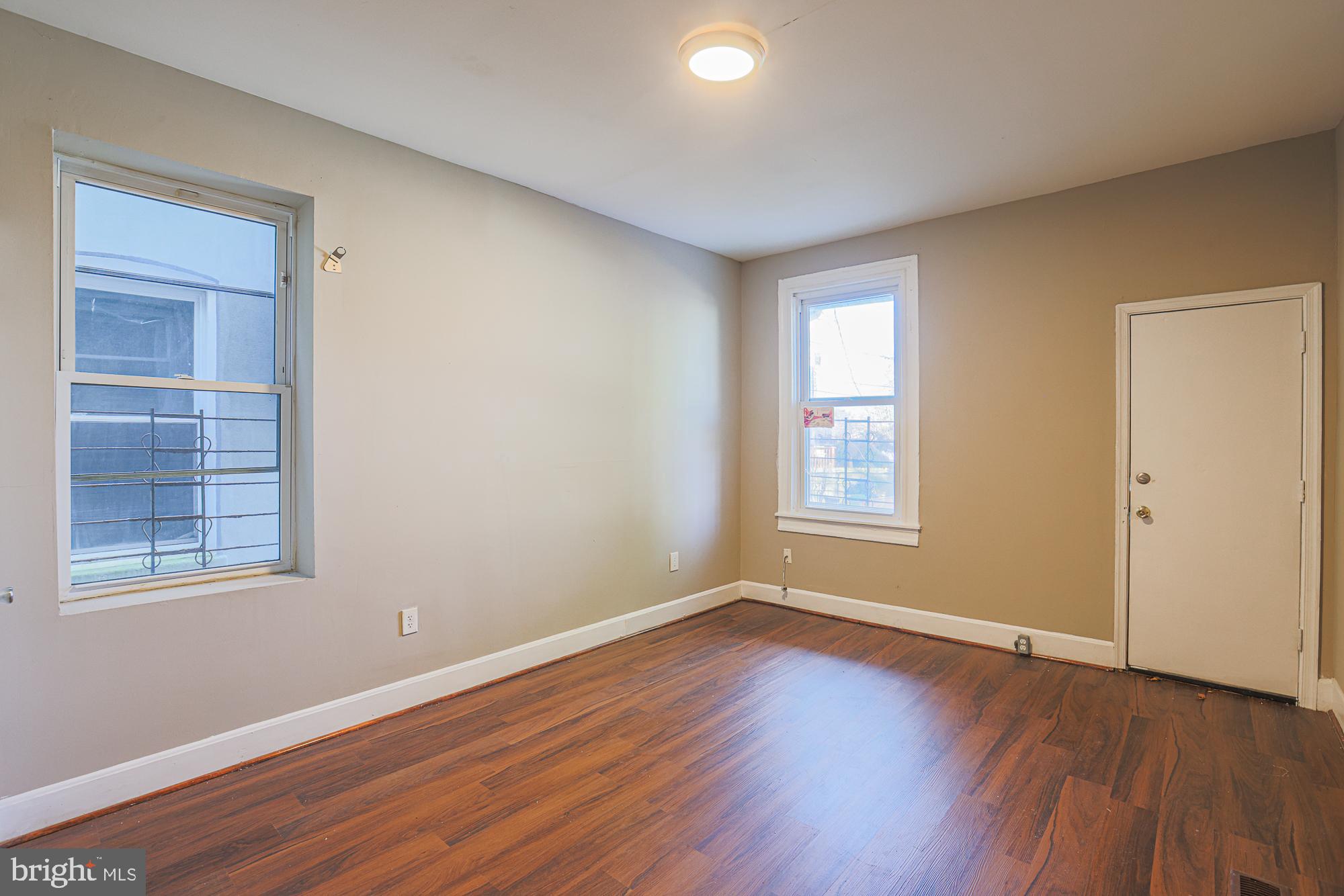 3012 Harford Road Baltimore, MD 21218 - Photo 22 of 42 a view of an empty room with wooden floor and a window