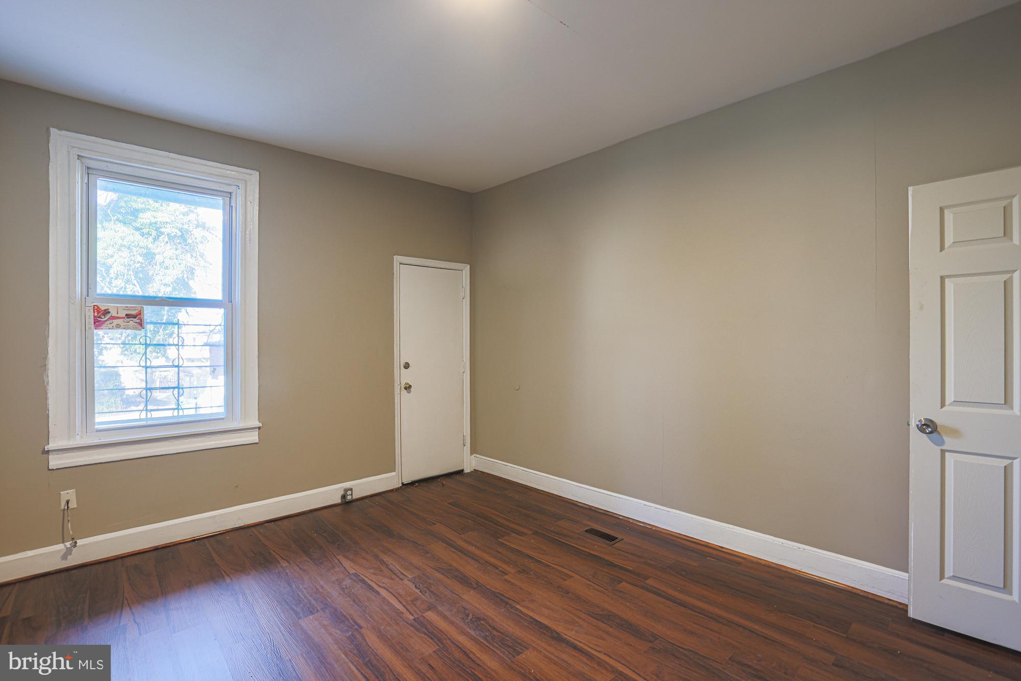 3012 Harford Road Baltimore, MD 21218 - Photo 23 of 42 a view of an empty room with wooden floor and a window