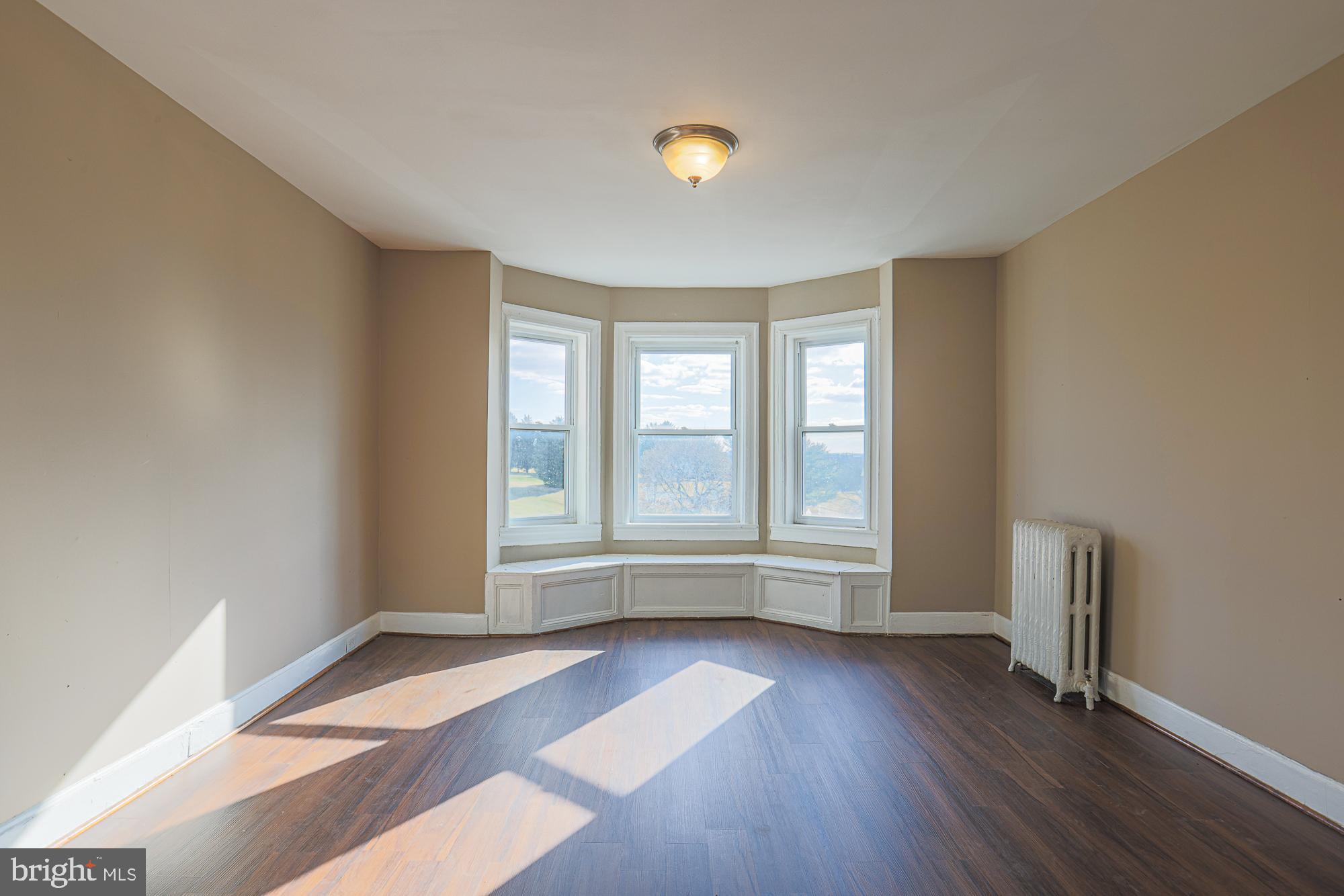 3012 Harford Road Baltimore, MD 21218 - Photo 33 of 42 an empty room with wooden floor and windows