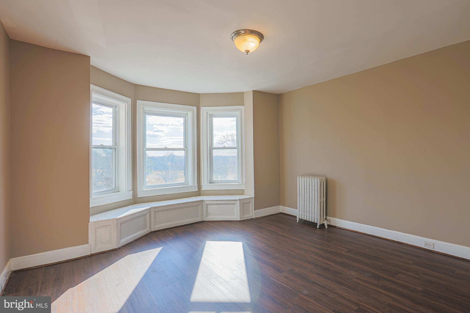 3012 Harford Road Baltimore, MD 21218 - Photo 34 of 42 an empty room with wooden floor and windows