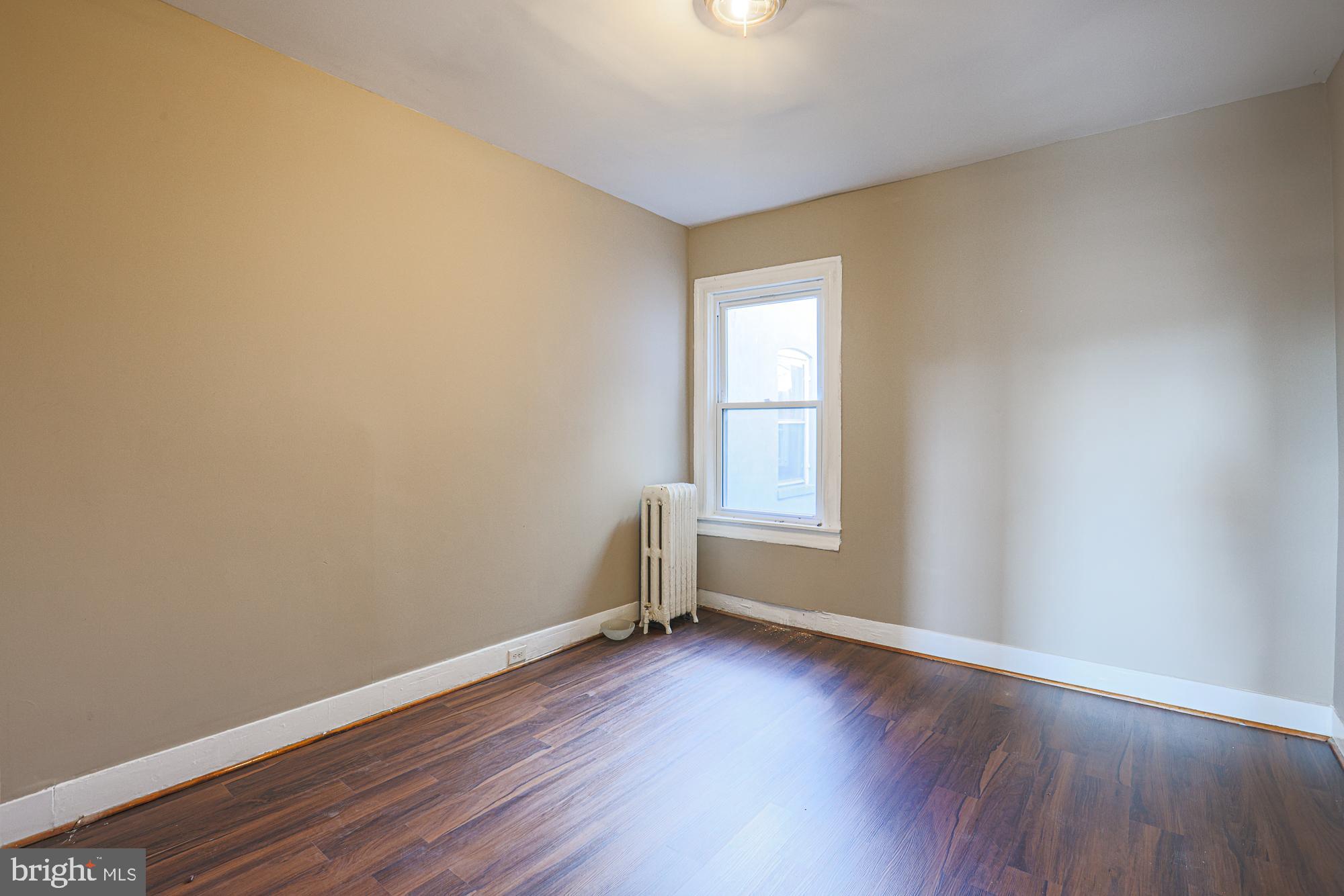 3012 Harford Road Baltimore, MD 21218 - Photo 36 of 42 an empty room with wooden floor and windows