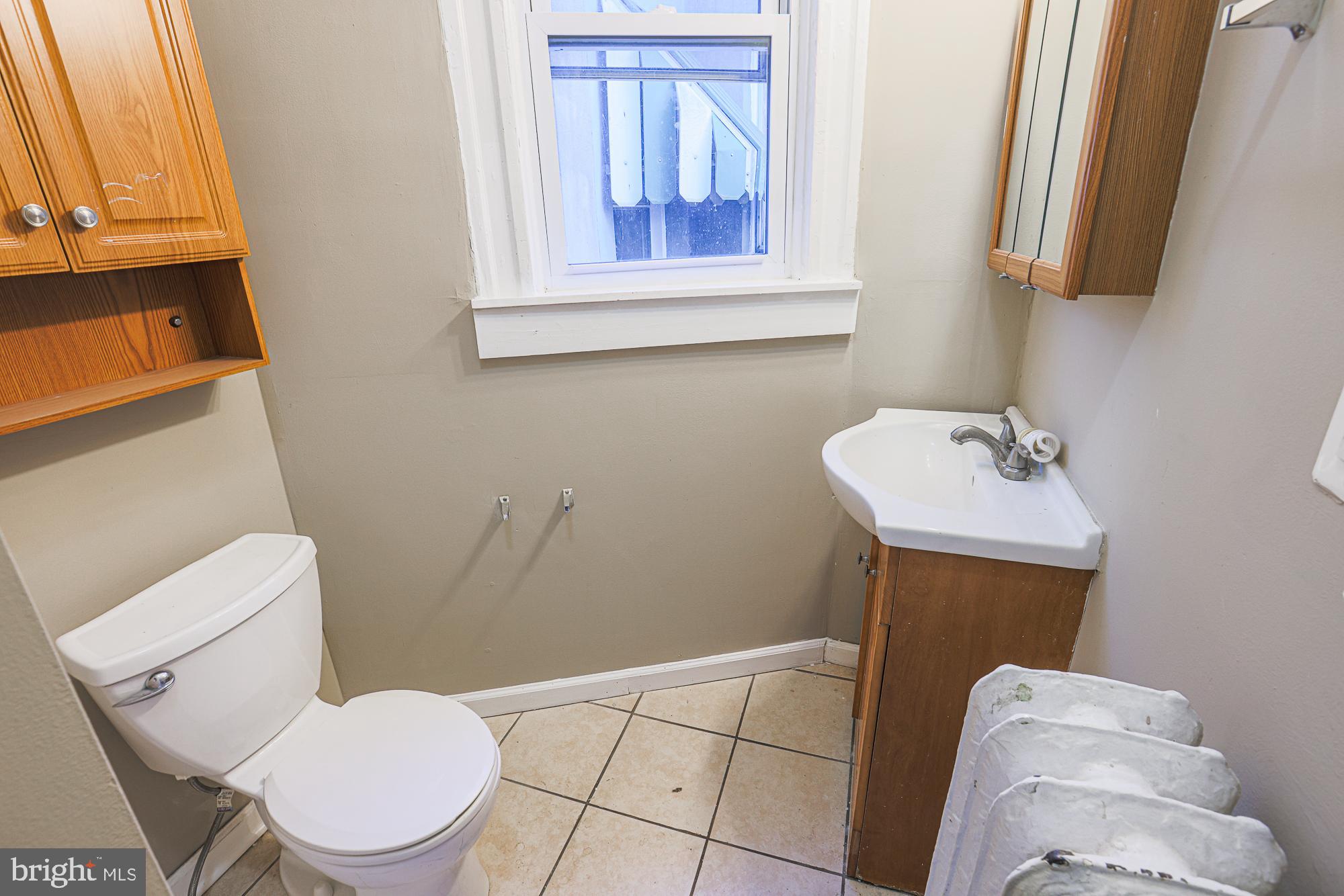 3012 Harford Road Baltimore, MD 21218 - Photo 39 of 42 a white toilet sitting next to a bathroom sink