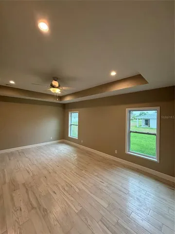 an empty room with windows and closet