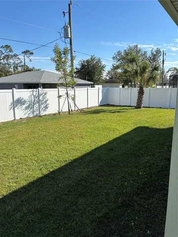 a view of a fountain in the backyard of a house