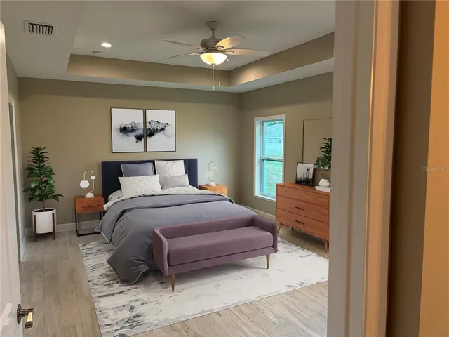a bedroom with a bed and a chandelier