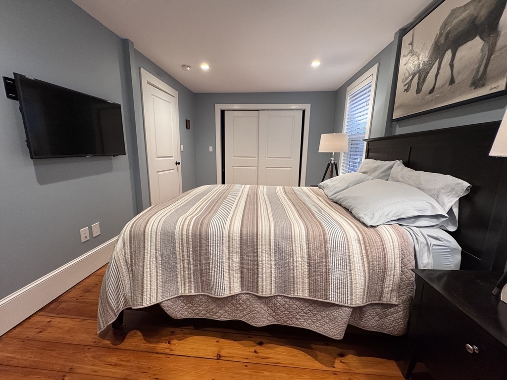 7 Hardy Street, Unit 1 Beverly, MA 01915 - Photo 11 of 24 a bedroom with a bed and a television