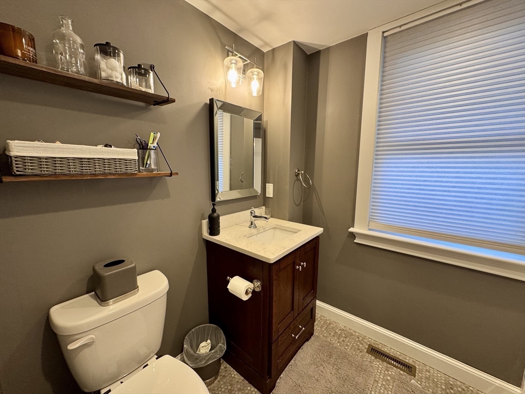 7 Hardy Street, Unit 1 Beverly, MA 01915 - Photo 12 of 24 a bathroom with a toilet a sink and mirror