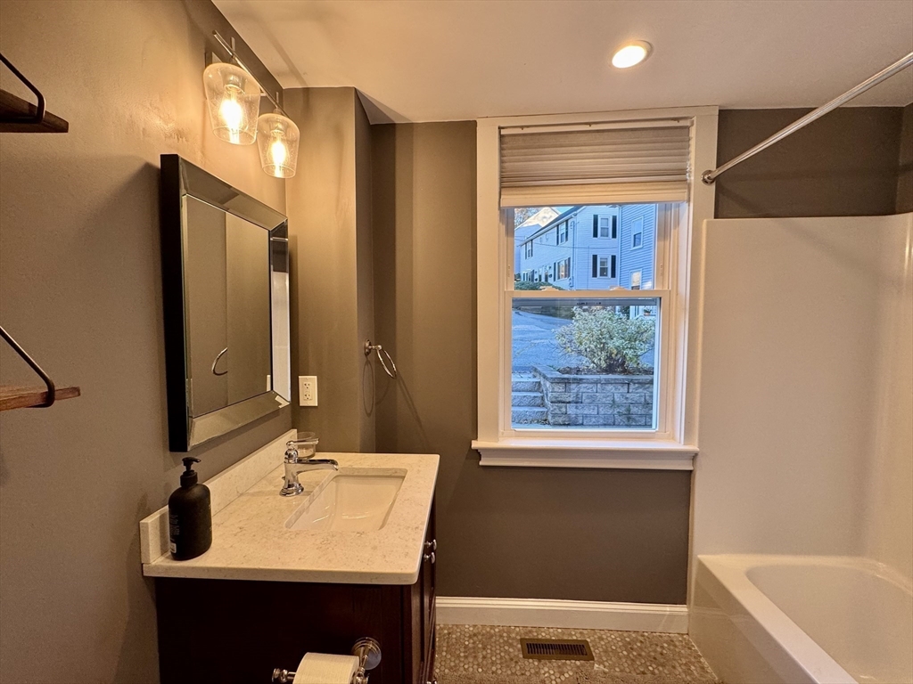 7 Hardy Street, Unit 1 Beverly, MA 01915 - Photo 13 of 24 a bathroom with a sink and a mirror
