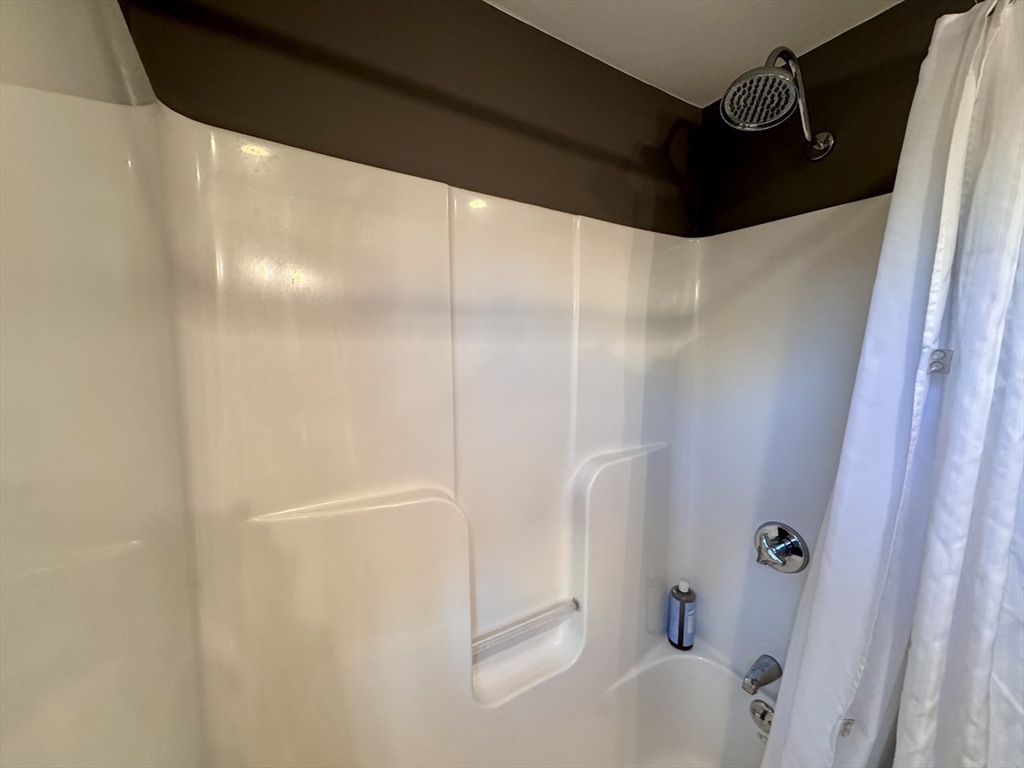 7 Hardy Street, Unit 1 Beverly, MA 01915 - Photo 14 of 24 a bathroom with a bathtub and shower