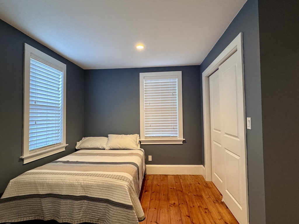 7 Hardy Street, Unit 1 Beverly, MA 01915 - Photo 15 of 24 a bedroom with a bed and a window