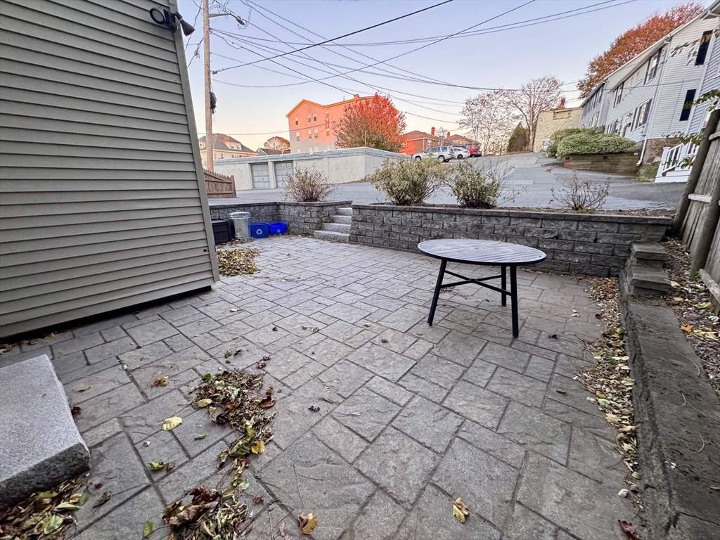 7 Hardy Street, Unit 1 Beverly, MA 01915 - Photo 18 of 24 a terrace with outdoor seating and a potted plant
